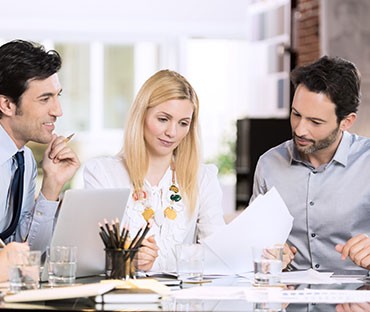 Two men and a woman working together